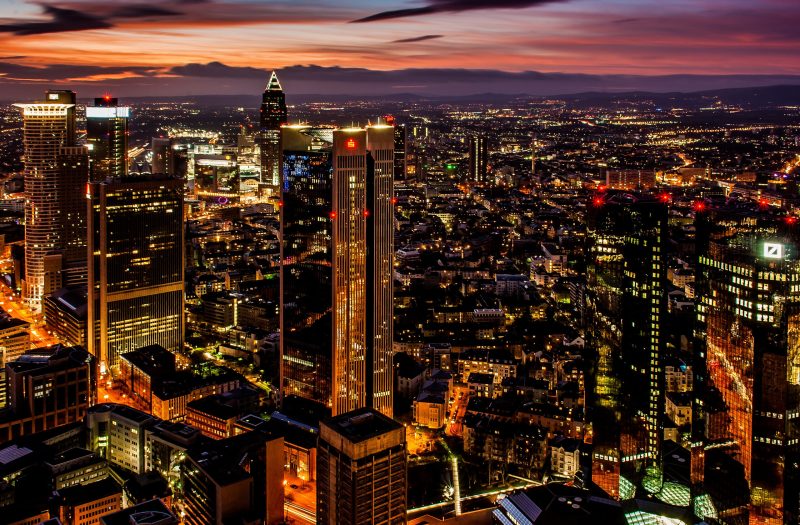 The beautiful city with high skyscrapers gleaming under the colourful sky at night