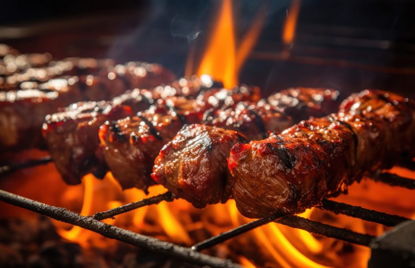 Meat hanging on skewers on the grill.